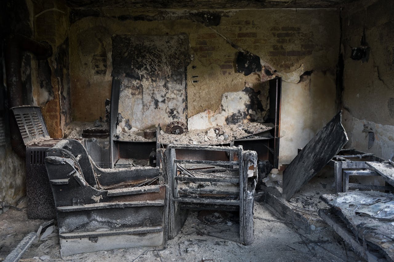 why-choose-us Charred interior of an abandoned building showing furniture damaged by fire in Germany.